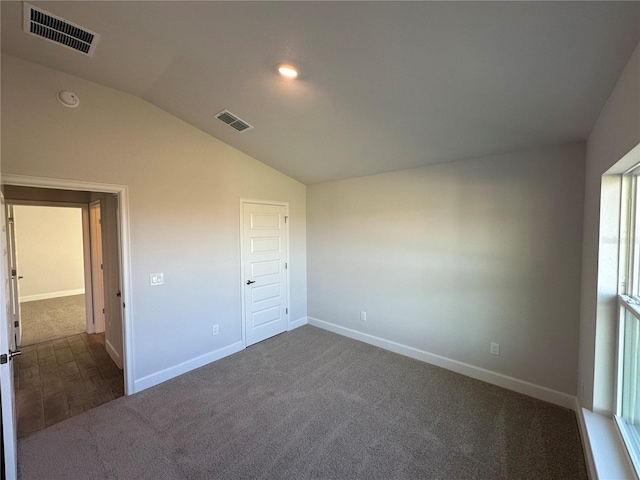 4489 SW 90th Pl, Ocala, FL 34476 - unfurnished bedroom with lofted ceiling, dark carpet, and baseboards