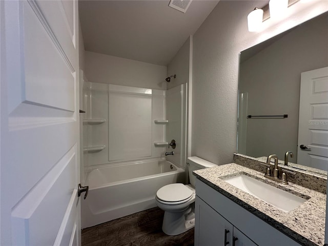 full bathroom featuring vanity, toilet, wood-type flooring, and shower / tub combination