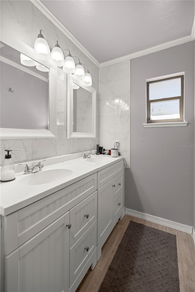 bathroom featuring hardwood / wood-style floors, vanity, and ornamental molding