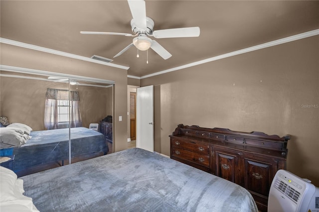 bedroom featuring ceiling fan, a closet, and crown molding