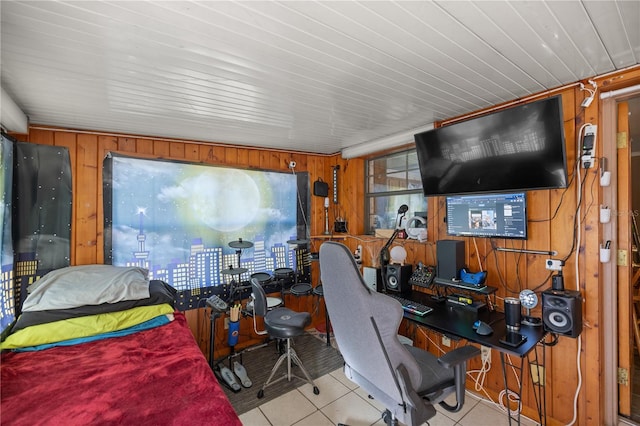 bedroom featuring wood walls and light tile patterned floors