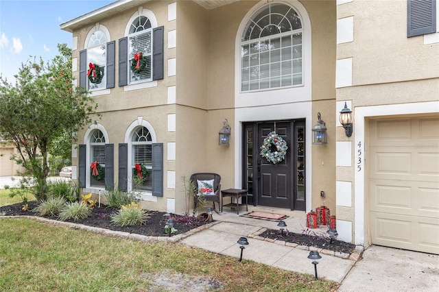 view of exterior entry featuring a garage