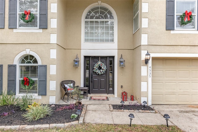 doorway to property with a garage