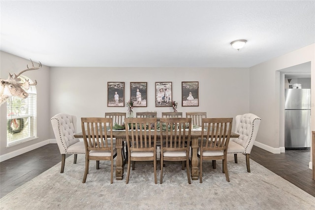 dining space with parquet flooring