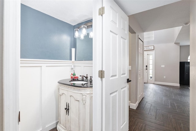 bathroom featuring parquet flooring and sink