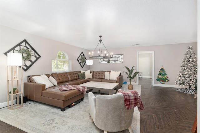 living room featuring parquet flooring and an inviting chandelier