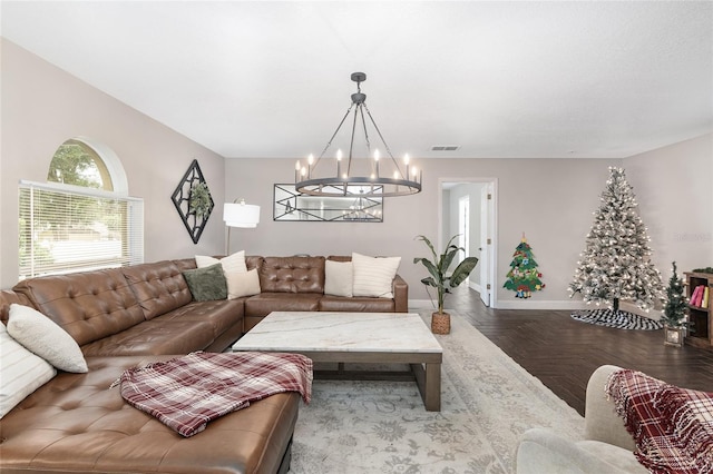 living room featuring parquet floors and an inviting chandelier