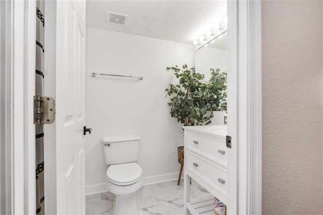 bathroom with toilet and vanity