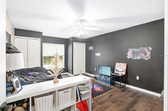 office featuring a textured ceiling, dark hardwood / wood-style floors, and ceiling fan