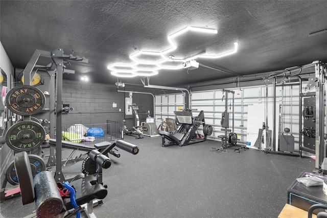 exercise room with a textured ceiling