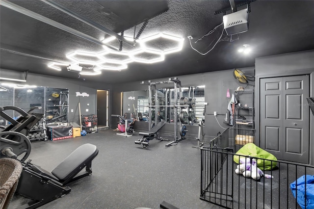 exercise room with a textured ceiling