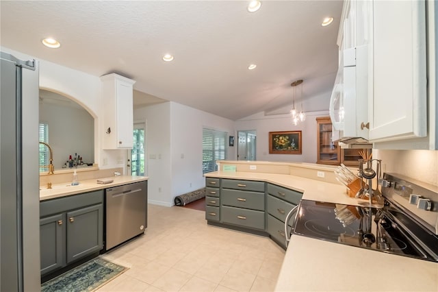 kitchen featuring gray cabinetry, lofted ceiling, white cabinetry, and stainless steel appliances