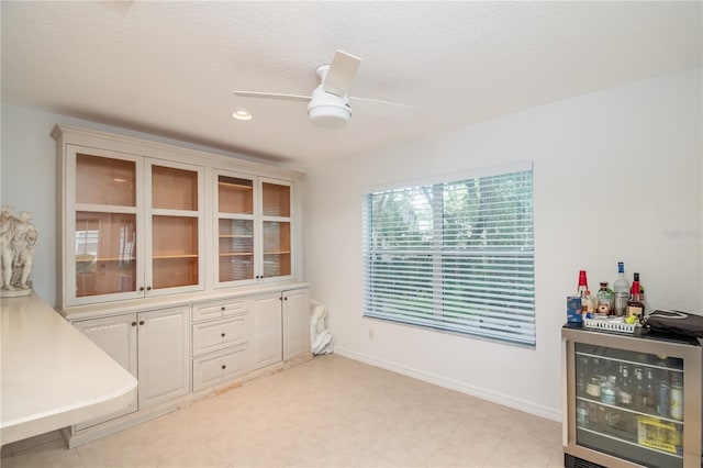 interior space with ceiling fan and wine cooler