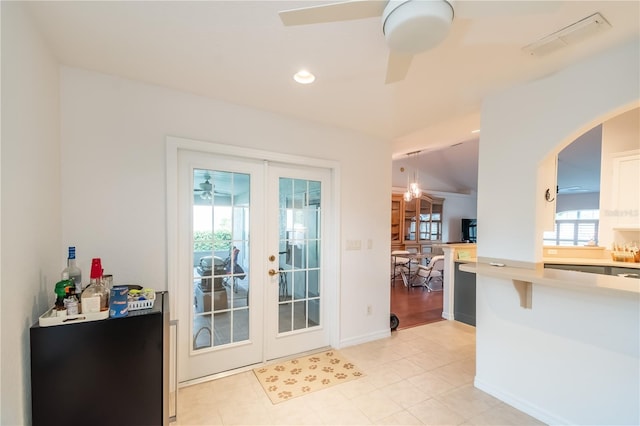 doorway featuring ceiling fan, light tile patterned flooring, and french doors