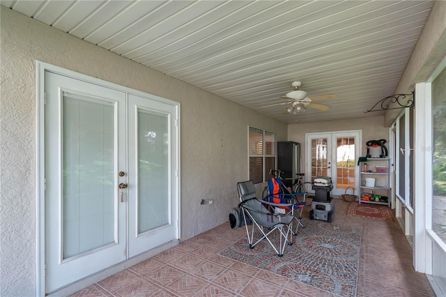 sunroom / solarium featuring french doors and ceiling fan