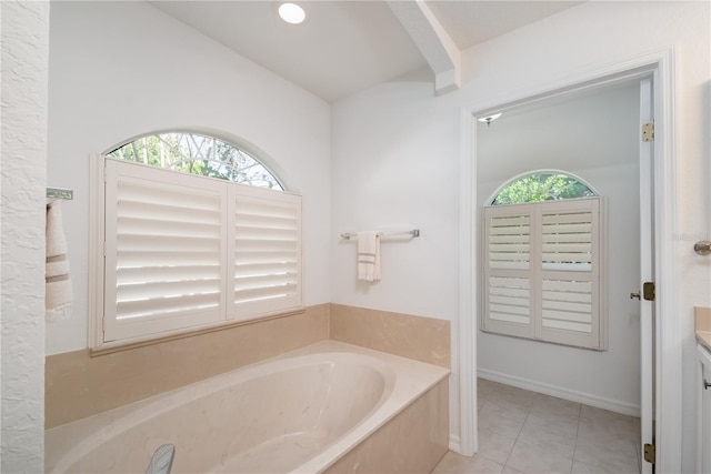 bathroom featuring a bathing tub, tile patterned flooring, and vanity