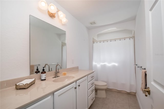 bathroom featuring tile patterned floors, vanity, and toilet