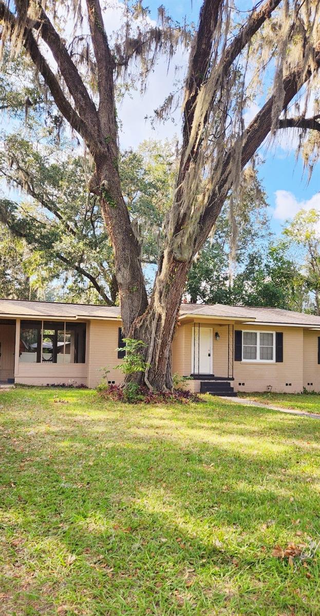 ranch-style home featuring a front lawn