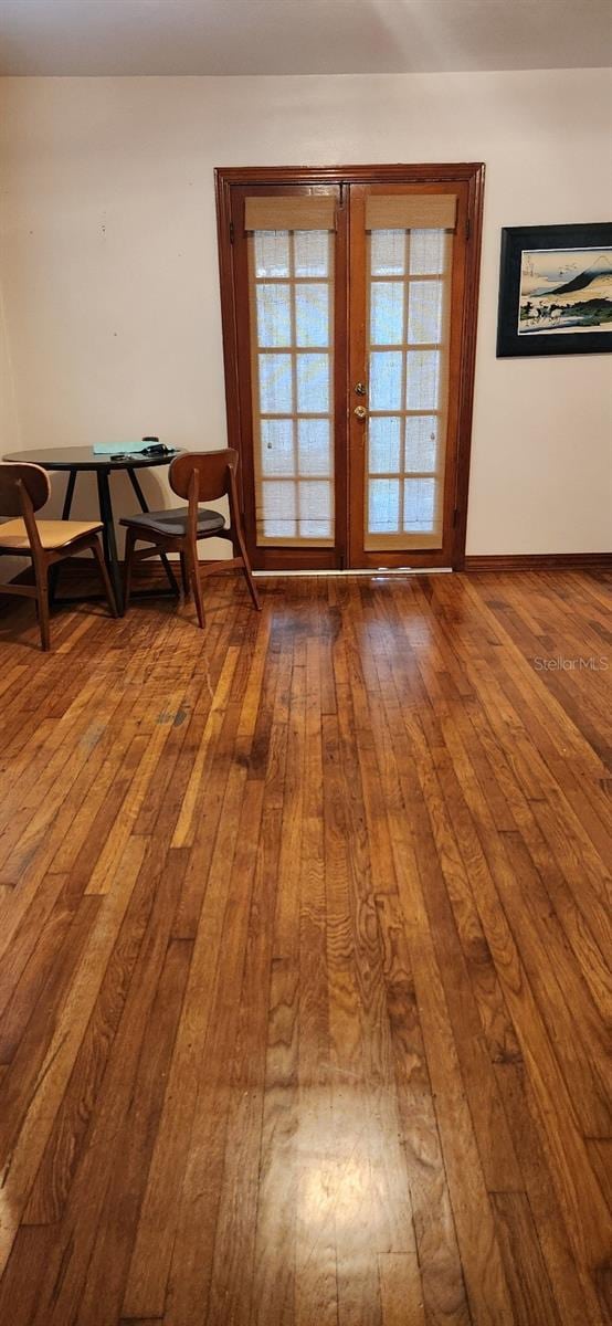 unfurnished dining area with french doors and wood-type flooring