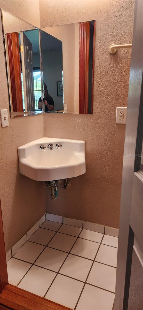 bathroom with tile patterned flooring and sink