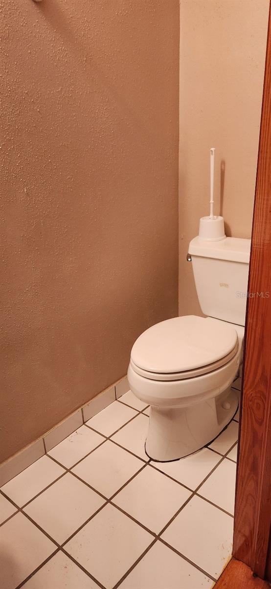 bathroom with tile patterned flooring and toilet