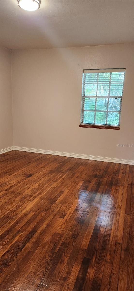 spare room featuring dark hardwood / wood-style flooring