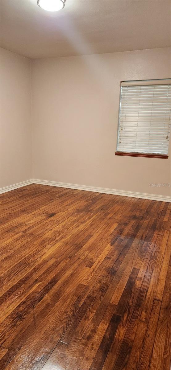 spare room featuring dark hardwood / wood-style floors