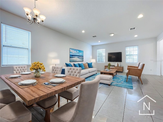 dining room featuring light tile patterned floors and a notable chandelier