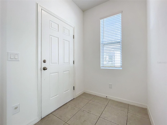 doorway to outside with light tile patterned floors and a healthy amount of sunlight