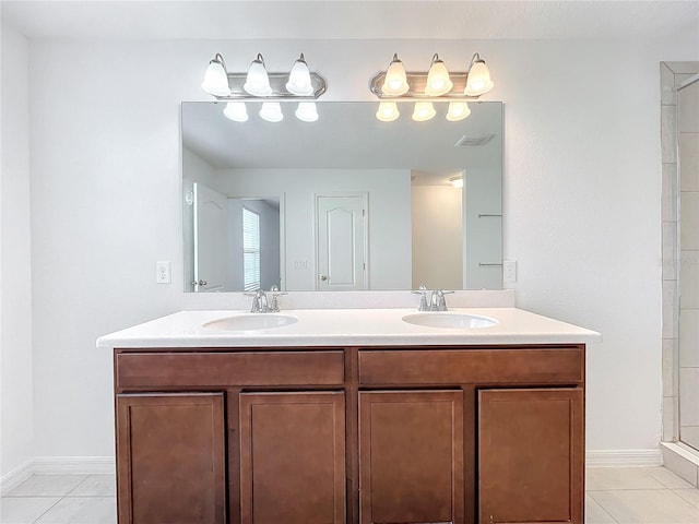 bathroom with tile patterned floors, vanity, and a shower with door