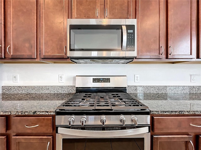 kitchen with stone counters and stainless steel appliances