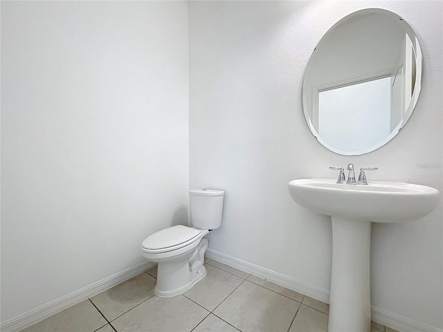 bathroom with tile patterned floors, toilet, and sink