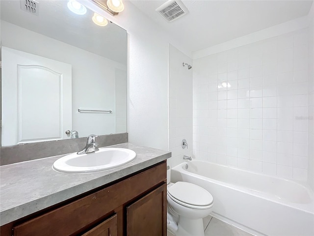 full bathroom featuring tile patterned flooring, vanity, tiled shower / bath combo, and toilet