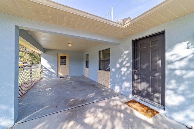 property entrance featuring stucco siding