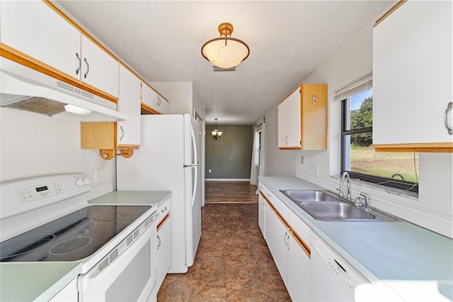 kitchen featuring under cabinet range hood, light countertops, white cabinets, white appliances, and a sink