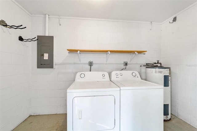 laundry room featuring electric panel, concrete block wall, water heater, and washing machine and clothes dryer