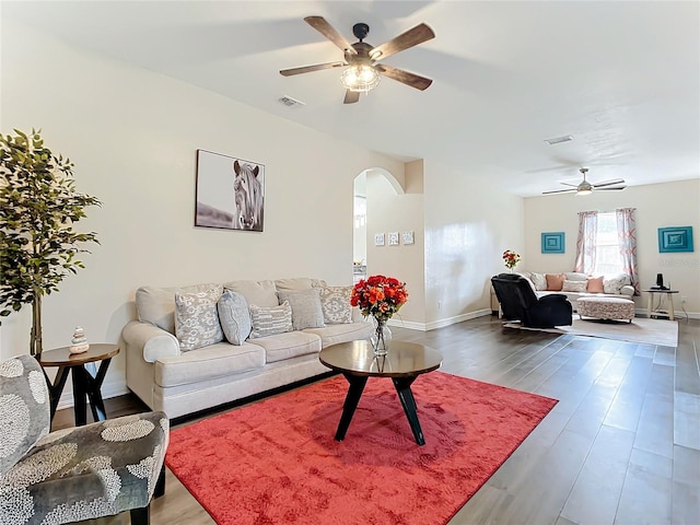 living room featuring ceiling fan and hardwood / wood-style floors