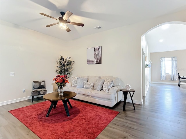 living room featuring ceiling fan and hardwood / wood-style flooring