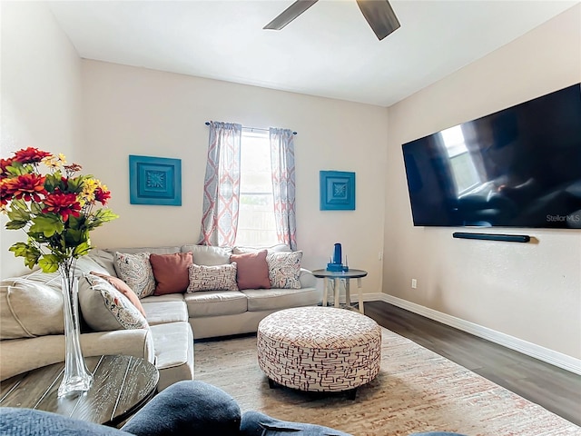 living room featuring ceiling fan and dark hardwood / wood-style flooring