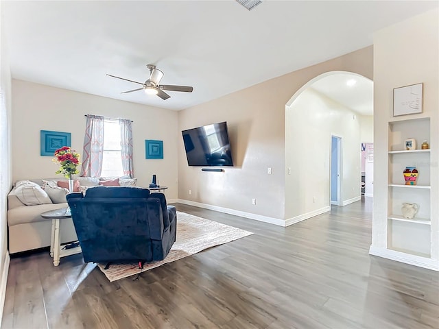 living room with hardwood / wood-style floors, ceiling fan, and built in features