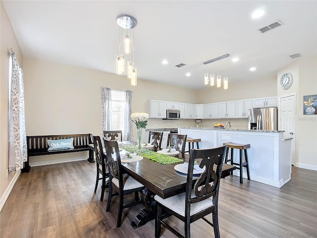 dining space featuring hardwood / wood-style floors