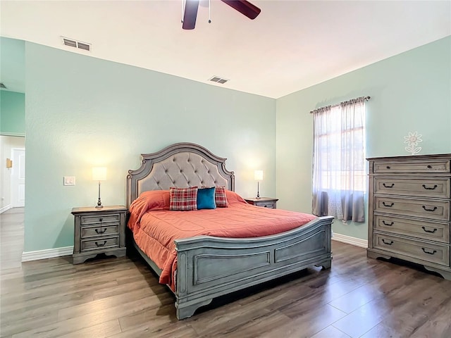 bedroom with ceiling fan and dark hardwood / wood-style flooring