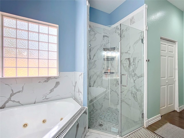 bathroom with a wealth of natural light and independent shower and bath