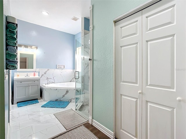 bathroom with shower with separate bathtub and vanity