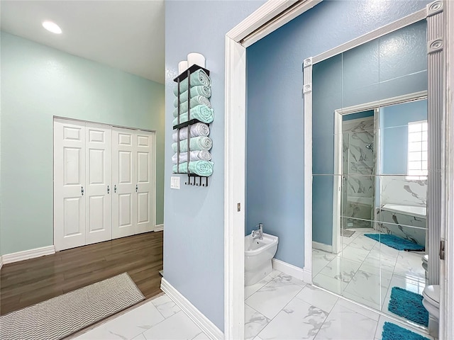 bathroom featuring walk in shower and a bidet