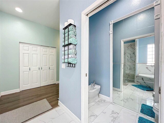 227 Locust Pass Crse, Ocala, FL 34472 - bathroom with a bidet, marble look tile flooring, baseboards, and a tub with marble appearance