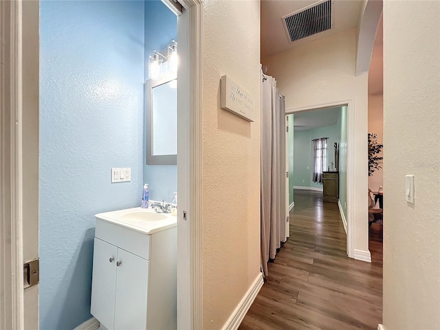 bathroom with vanity and hardwood / wood-style floors