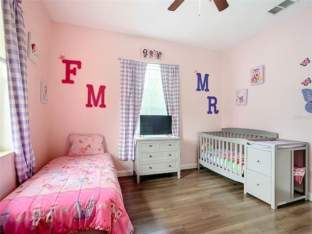 bedroom with ceiling fan and dark hardwood / wood-style floors