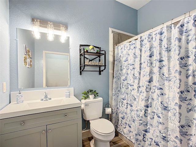 bathroom featuring toilet, a shower with shower curtain, vanity, and hardwood / wood-style flooring