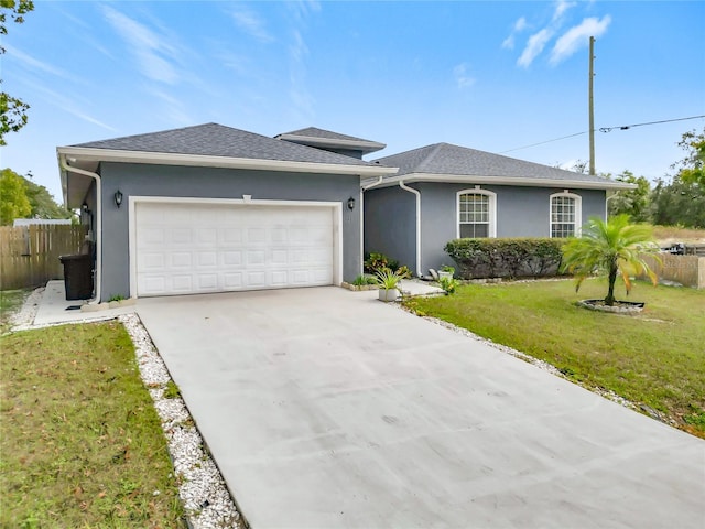 single story home featuring a front yard and a garage